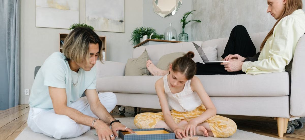 A family enjoying leisure and remote work together in a cozy home setting.