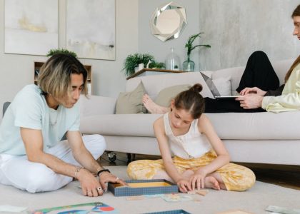 A family enjoying leisure and remote work together in a cozy home setting.